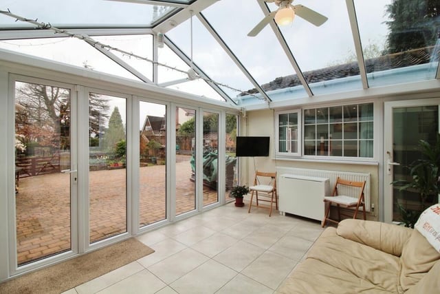 Moving on now to the charming conservatory that seamlessly extends the living space at Portland House. Large doors lead to the garden.