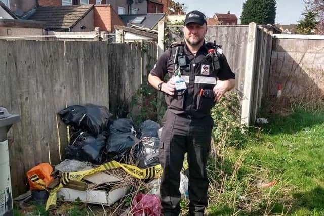 One of Ashfield District Council's community protection officers with fly-tipped waste on Beardall Street