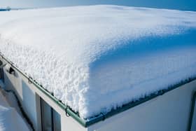 Heavy snow on a flat roof can cause structural damage.