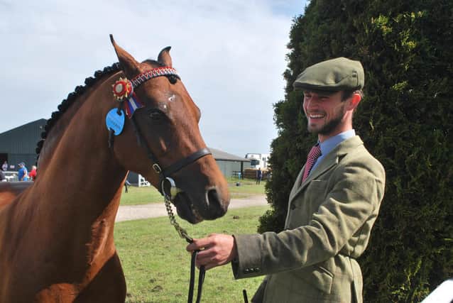 Shane Rogers, 26, from Cheshire, with Rutherwood Jubilee Diamond, just ahead of the judging in their Riding Pony Stallions class.