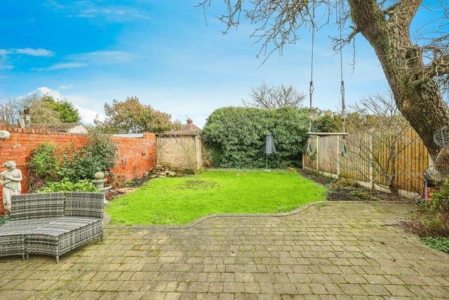 As we take a look outside, here is the sizeable back garden, which is mainly laid to lawn, with mature borders, but also includes a block-paved patio area and a brick-built shed.
