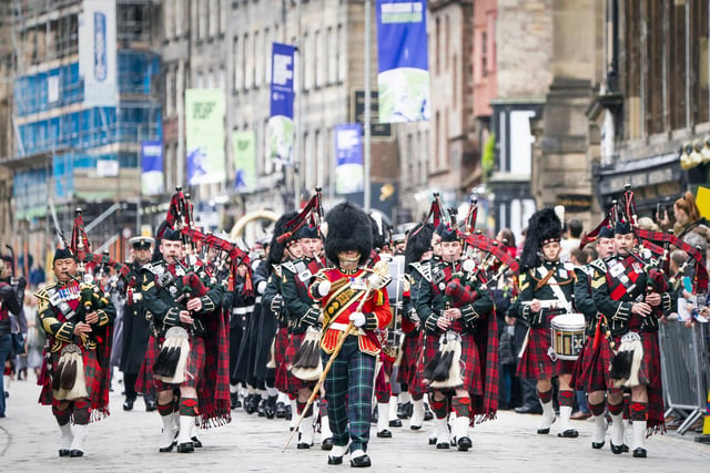 Massed pipes and drums parade down the Royal Mile during the Remembrance Sunday service, past the Stone of Remembrance outside Edinburgh City Chambers in Edinburgh.