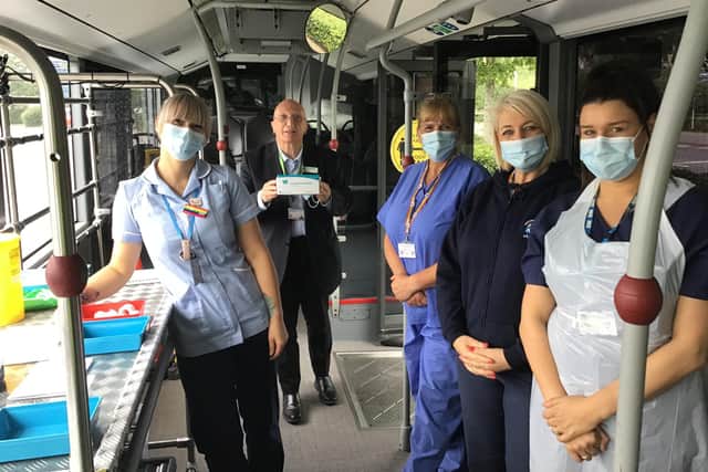 Coun John Wimott with staff members on board the vaccine bus in Hucknall