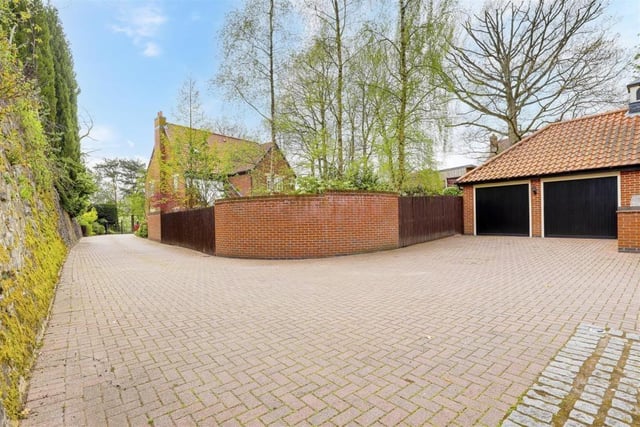The block-paved driveway at the front of the property wends its way round to this double garage. As you can see, there is plenty of space for off-road parking.