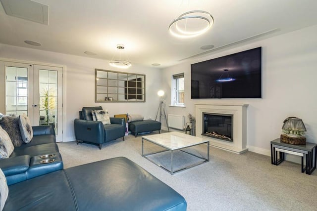 Put your feet up and relax in front of the big-screen OLED TV and feature fireplace, with electric fire, in the living room.