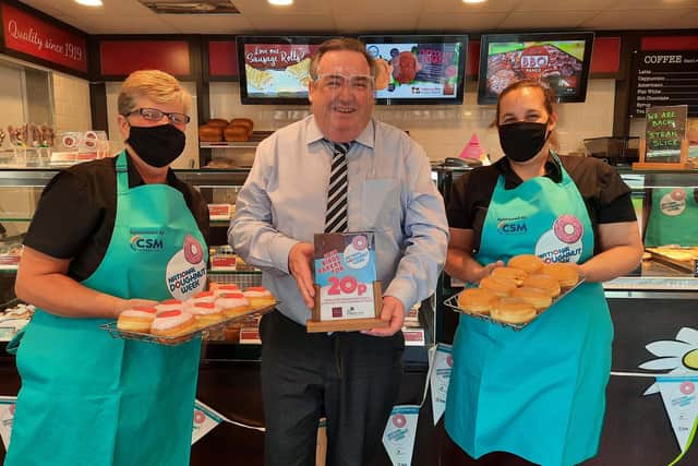 Mike Holling, sales & marketing director at Birds, and shop staff members prepare for National Doughnut Week.