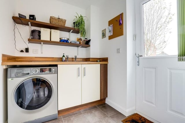 Just off the kitchen/diner is this useful utility room, which has space and plumbing for a washing machine. There are fitted base units with worktops, a stainless steel sink with drainer, and also a tiled floor.
