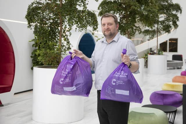 Slimming World employee Sean Chapman with some of the bags of clothes donated to the big throw back