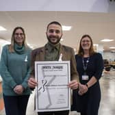 Antonio Taylor (community safety manager) with Coun Helen-Ann Smith (left, deputy leader) and Emma Jimmick (domestic violence and vulnerability officer) with the authority's white ribbon accreditation. Photo: ADC