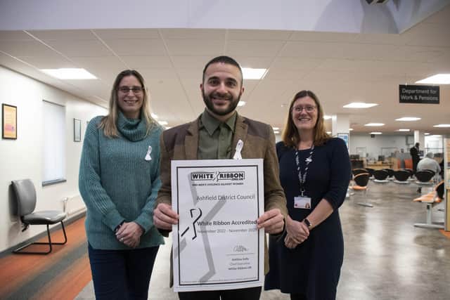Antonio Taylor (community safety manager) with Coun Helen-Ann Smith (left, deputy leader) and Emma Jimmick (domestic violence and vulnerability officer) with the authority's white ribbon accreditation. Photo: ADC