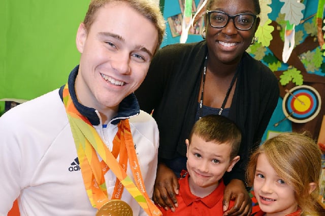 Paralympian gold medalist Ollie Hynd visits Bulwell St Marys primary school. Sports coordinator Azuraye Williams, Lexie Roaa and keelum Hammond.
