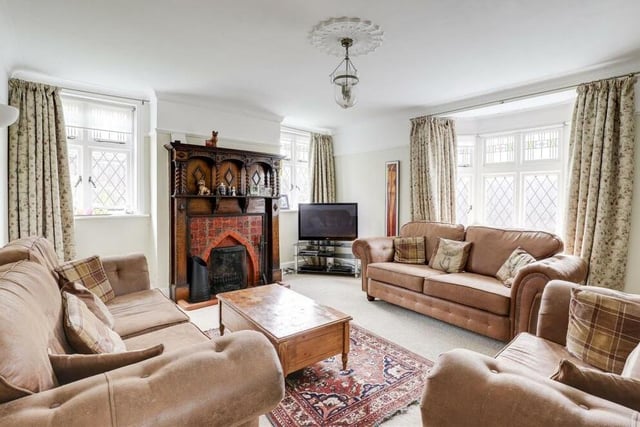 On a cold and wet December day, it makes sense to begin our tour of the £425,000 property by heading for the warmth and comfort of the large living room, which is distinguished by a feature fireplace with decorative surround.