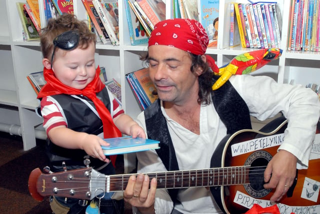 2008: Lawson Charles, aged one, hands a book to Peter Lynn at a pirate day at Bulwell Library to help promote Book Start Day.