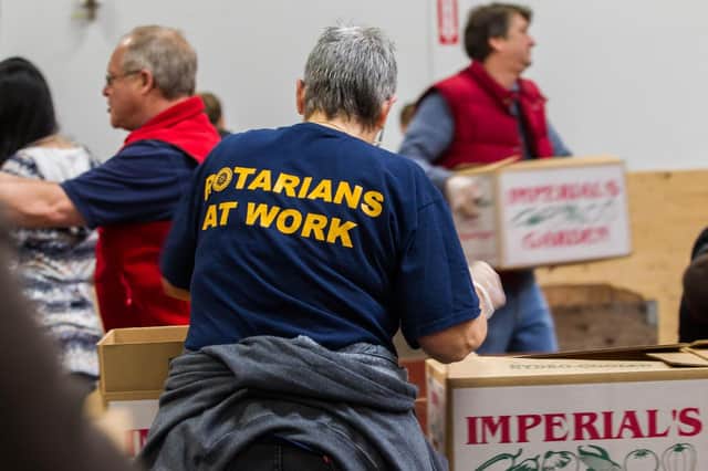 Rotarians packing boxes ready for distribution to food banks. Photo by Alyce Henson.