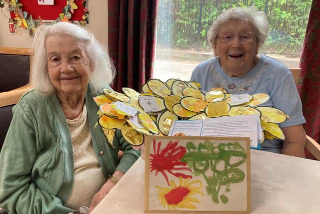 Fairway View residents Phyllis and Mavis with their sunflowers from the school children