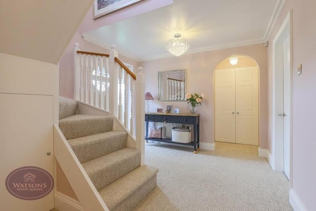 As we prepare to go upstairs, let's pass through the large and attractive entrance hall. It has under-stairs storage and a built-in storage cupboard.
