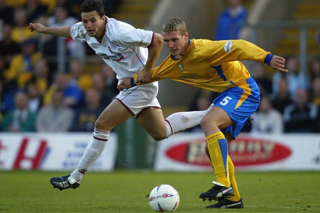 Marc Richards of Northampton is challenged by Rhys Day of Mansfield during the 2004 play-off semi-final.