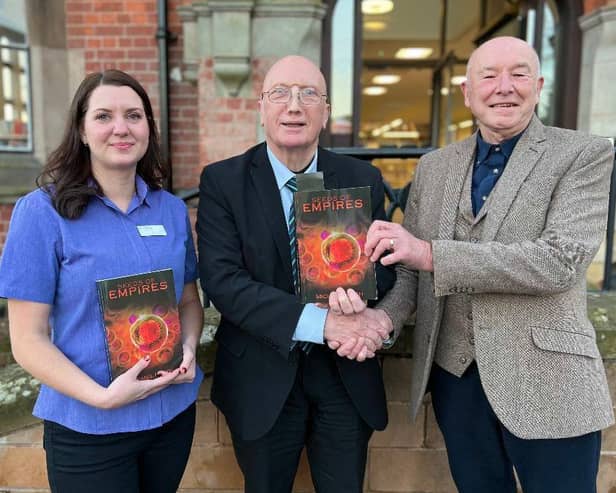 Michael Heath (right) has presented a copy of his debut novel to Hucknall Library. Receiving the book are Coun John Wilmott and Jo Cannon, library customer services advisor