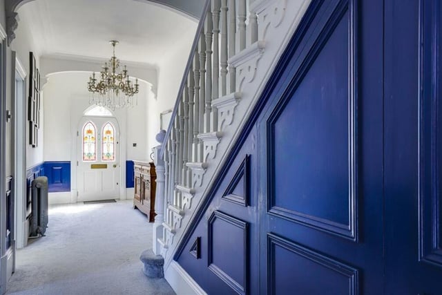 Once through the front door, with its stained glass inserts, you are greeted by this inviting entrance hall. It has a decorative ceiling arch, patterned, tiled floor, panelled walls, two column radiators and coving to the ceiling.