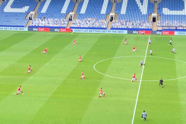 Nottingham Forest players take a knee for Black Lives Matter ahead of their match at Sheffield Wednesday, in front of empty stands and cardboard cutouts of fans at Hillsborough Stadium on June 20, 2020.