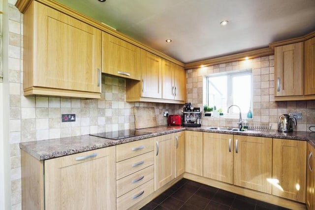 A fully fitted kitchen boasts a range of units for storage, with space for appliances too. Nearby is a handy utility room and also a downstairs bathroom.