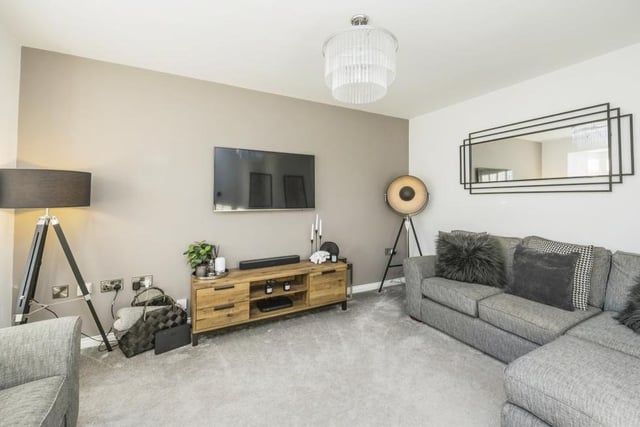 Our tour of the Canberra Crescent property begins in this lovely living room or lounge. It is a comfortable, stylish space with a carpeted floor.