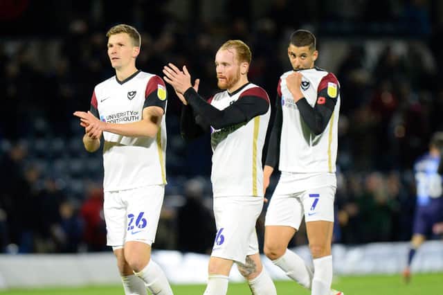 Paul Downing and Connor Ogilvie applaud the travelling Pompey fans at the final whistle.  Picture: Graham Hunt