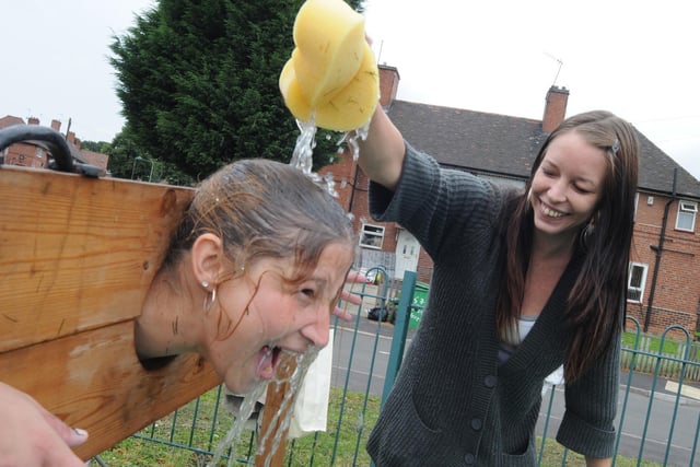 2010: Kerry Attenborough gives her younger sister Tanya a soaking at the Bulwell Hall Estate Community Fun Day.