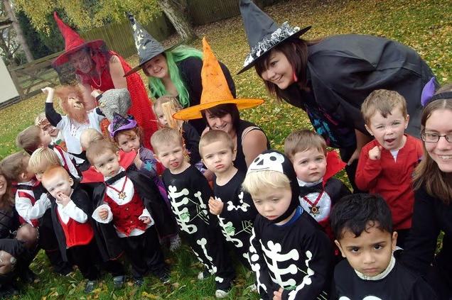 Dressed in festive fancy dress, children and their carers come together to celebrate Halloween at Hucknall Day Nursery in 2009