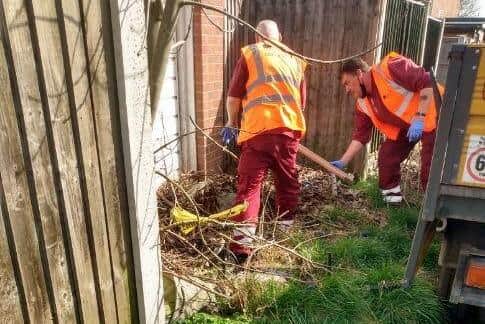 Members of the council's environment team clearing waste on Beardall Street