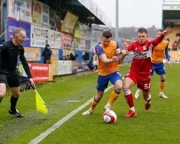 Mansfield Town midfielder Ollie Clarke  battles with Middlesbrough midfielder Caolan Boyd-Munce. Picture by Chris Holloway/The Bigger Picture.media