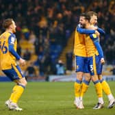 Mansfield Town defender Stephen McLaughlin celebrates his winning goal against Salford with team mates. Photo by Chris Holloway/The Bigger Picture.media