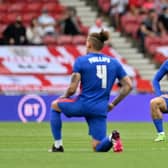 England players Kalvin Phillips and Jack Grealish take the knee before the friendly with Romania at the Riverside on Sunday.  (Photo by PAUL ELLIS/POOL/AFP via Getty Images)