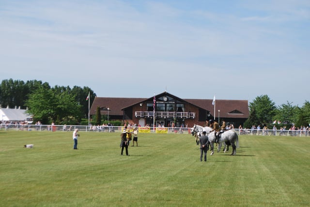 Equestrian judging in the main ring of the Nottinghamshire County Show, in front of the Cedric Ford Pavilion at the Newark Showground.