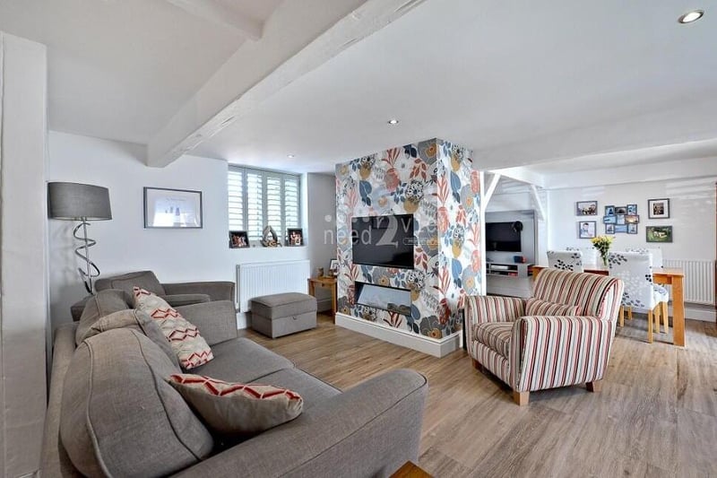 Let's begin our tour of the Mill Yard cottage in the eyecatching lounge, which is a spacious family room with a modern fireplace and windows to the front and back of the property.