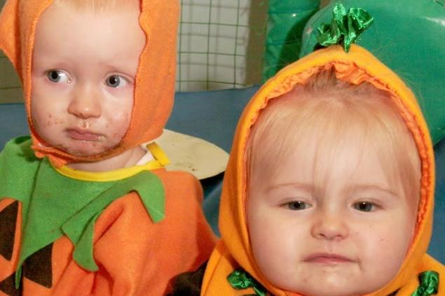 Looking bright and festive in the autumn of 2006, a young duo models matching pumpkin outfits during a spooky Halloween event at Hucknall Leisure Centre