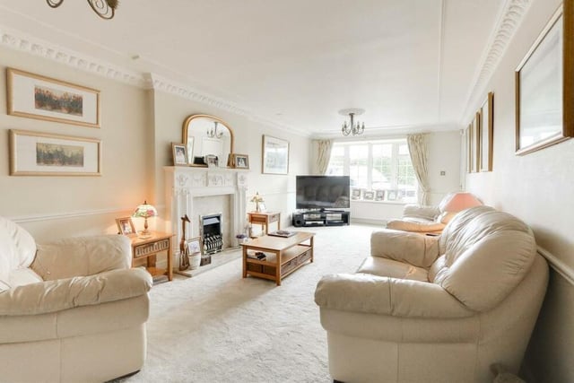 The living room oozes luxury and style, with its feature fireplace and double-glazed sash window facing the front of the £475,000-plus house.