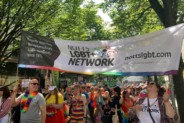 Notts LGBT+ Network proudly holding their banner.