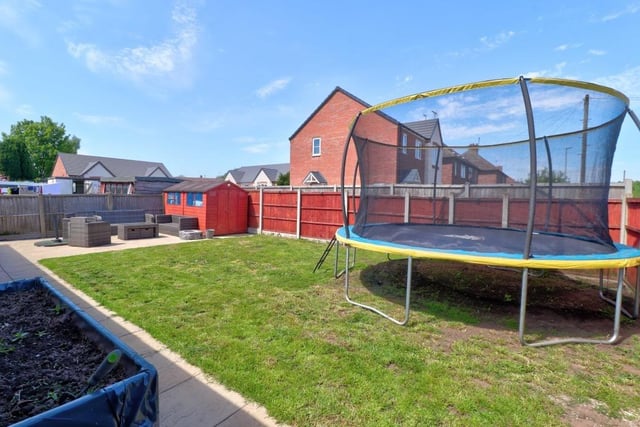 As we say farewell to the Appleton Road house, let's take a quick peek at the back garden, which is mainly laid to lawn but also features an attractive patio area.