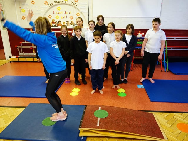 Flipping fantastic -year six youngsters at King Edward Primary School keenly watch Samantha Scotland schools co-ordinator at Beth Tweddle Gymnastics 
.