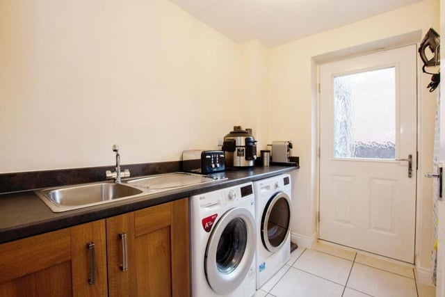 The utility room, which sits next to the kitchen, is highly convenient, especially as it has space and plumbing for white goods. It offers a second sink unit and extra prep space.
