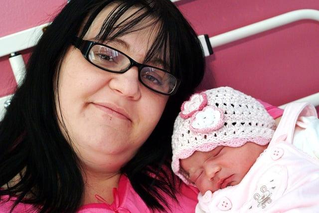 Michelle Homer, of Sutton, with her New Years' Day baby, who was unnamed at the time, born at 7.40pm in 2009. A daughter for partner Joe Young and sister to Jamie and Jason.