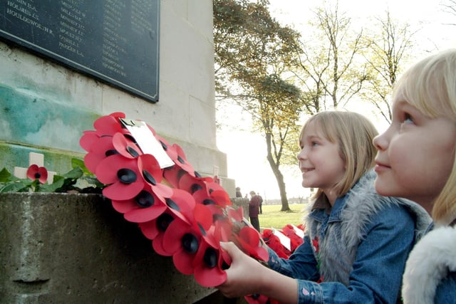 Youngsters Lauren,10, and Jessica Walter, 8, lay a wreath at the cenotaph on Remembrance Day at Titchfield Park in 2006