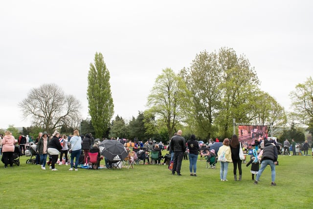 People braved the wet weather to watch the Coronation service on the big screen in Hucknall's Titchfield Park