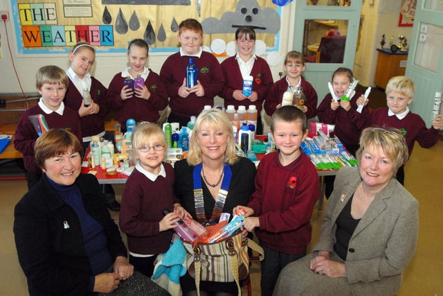 Birklands Primary School pupils, Jessica Martin and Liam Grimley hand over some of the collected goods for the Warsop Inner Wheel's 'Joy bags', which are distributed to families through the Nottinghamshire Police convoys. The club's president, Christine Fretwell,  is pictured with her Overseas officer Lesley Palmer, left and club correspondent Sue Pasierb right, following a special assembly when the toiletry items were handed over.