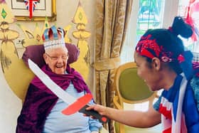 A resident is knighted by activities co-ordinator Natasha Lindo.