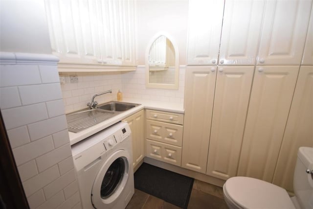 Just off the kitchen diner on the ground floor is this handy utility room, WC and cloakroom. It is fitted with wall and base units for storage, a stainless steel sink, plumbing for a washing machine and a fitted gas central heating boiler that has a warranty until 2029.