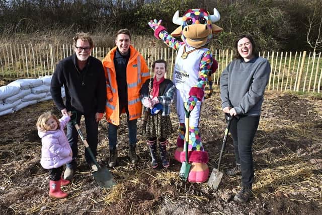 Commonwealth Games mascot Perry the Bull joins youngsters and volunteers at a Tiny Forest planting