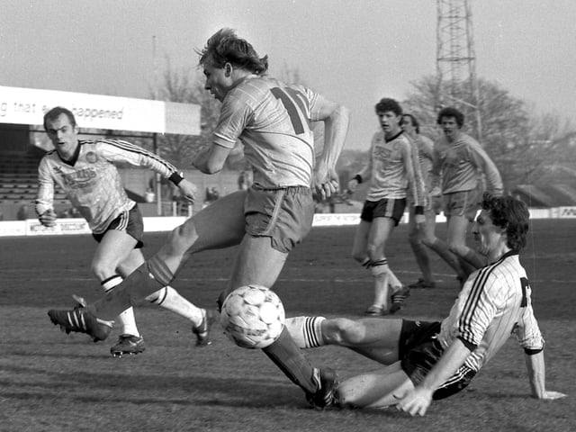 Dave Caldwell is tackled during the visit of Hereford United