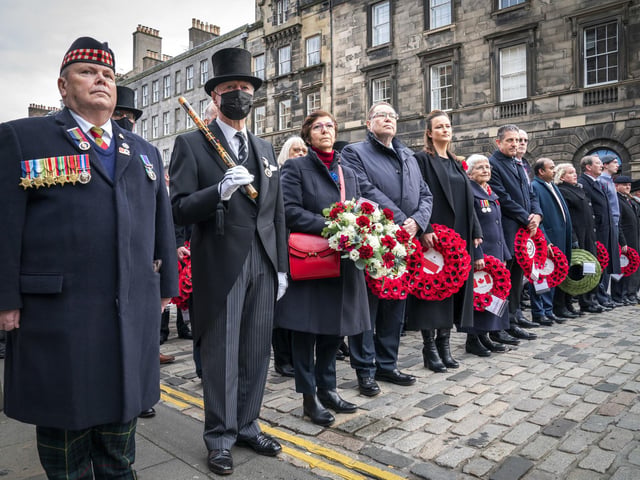 Dignitaries wait to lay their wreaths during the Remembrance Sunday service at the Stone of Remembrance outside Edinburgh City Chambers in Edinburgh.